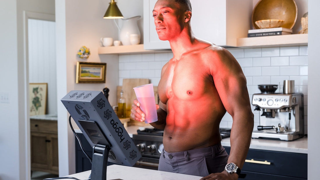 Man using a Hooga PRO300 red light therapy panel in his kitchen
