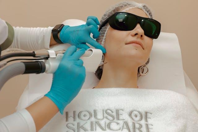 Woman getting laser treatment while wearing protective glasses