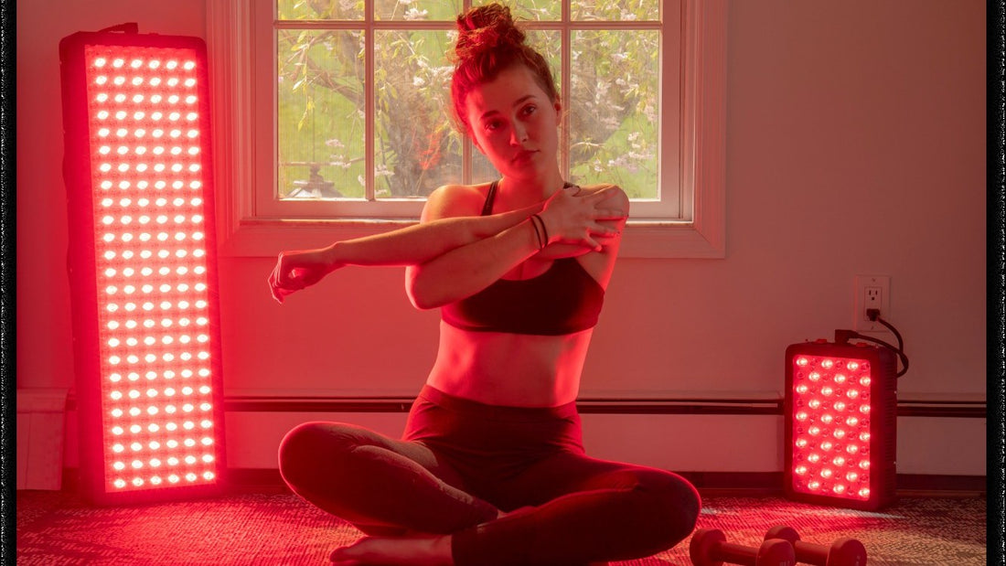 Woman stretching between Hooga red light therapy panels at home