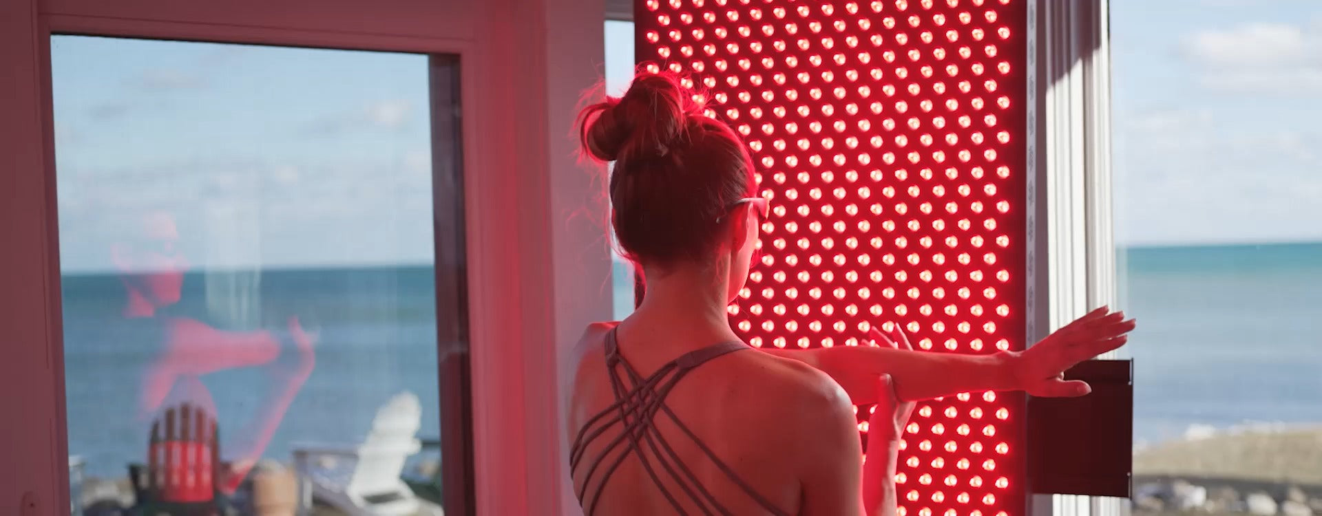 Person using a Hooga red light therapy panel at home